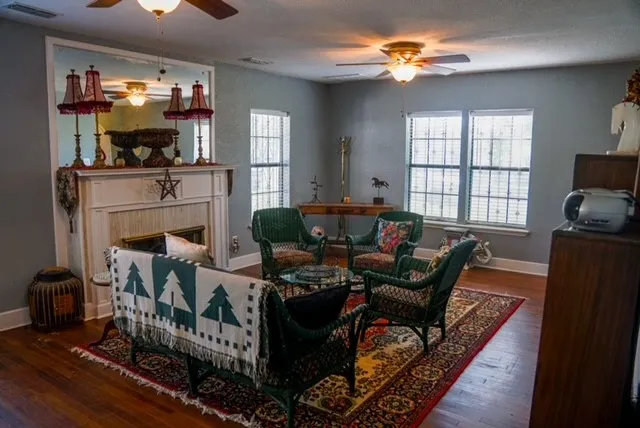 a living room with furniture a fireplace and a window