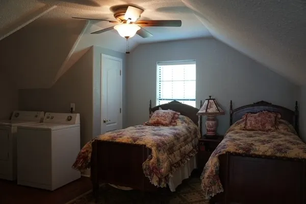 a bedroom with two beds and a chandelier
