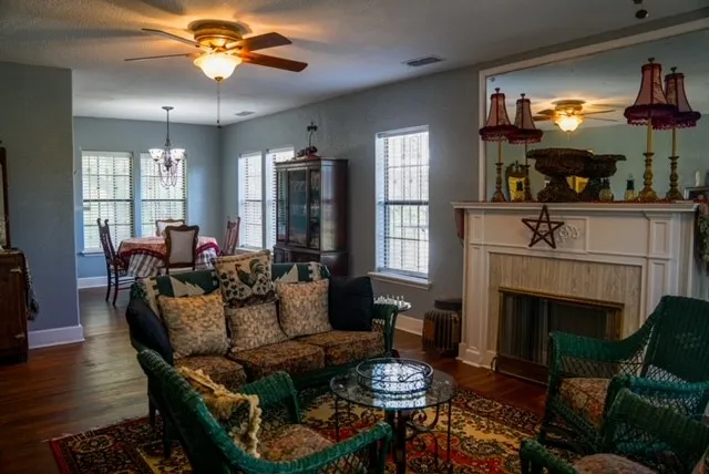 a living room with furniture a fireplace and a flat screen tv