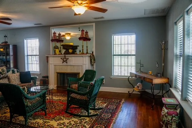a living room with furniture fireplace and window
