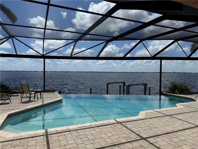 a view of a patio with table and chairs under an umbrella