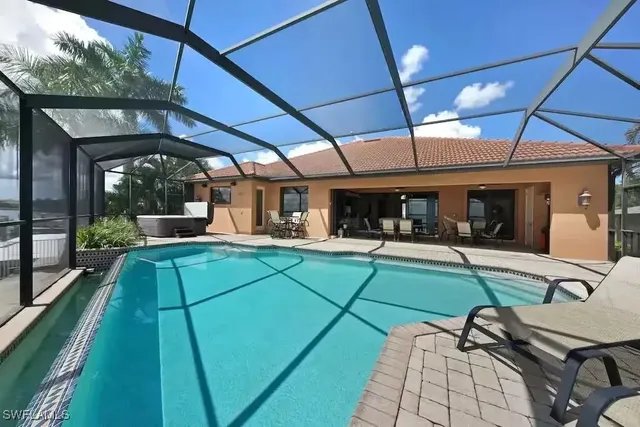 a outdoor space with a large pool table and chairs