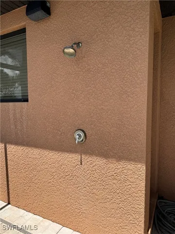 a living room with furniture a flat screen tv and a window