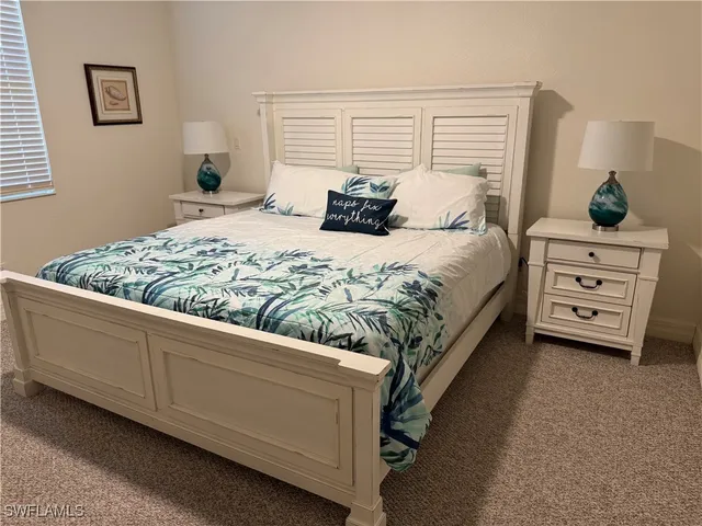 a bedroom with a bed couch and window