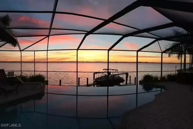 a living room with furniture and floor to ceiling window
