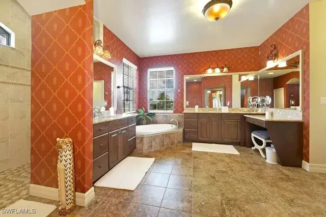 a view of front door with table and a chair