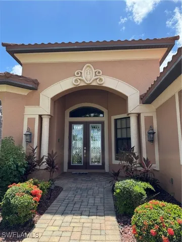 a front view of a house with a lots of potted plants