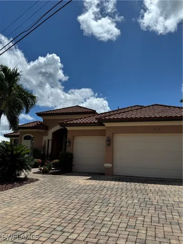 a view of a house with a backyard