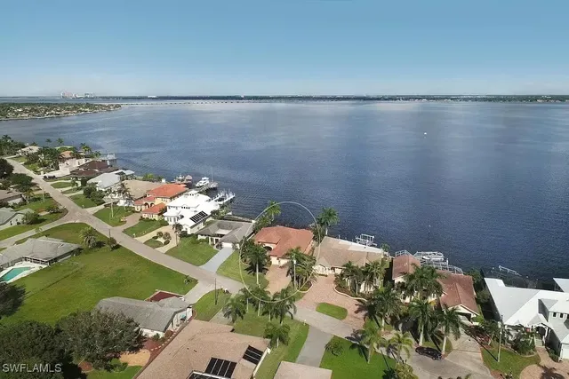 an aerial view of a house with garden space and lake view