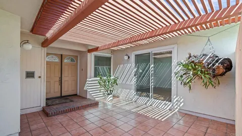 a view of a patio with table and chairs and potted plants
