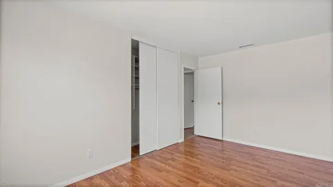 a view of a room with wooden floor