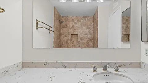 a bathroom with a bathtub and a sink