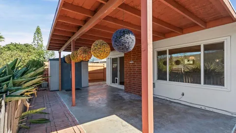 a view of a room with wooden floor and door