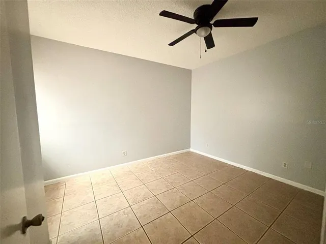 a bathroom with a granite countertop sink a toilet a mirror and shower