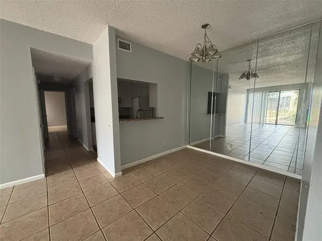 a kitchen with granite countertop a sink stove and refrigerator