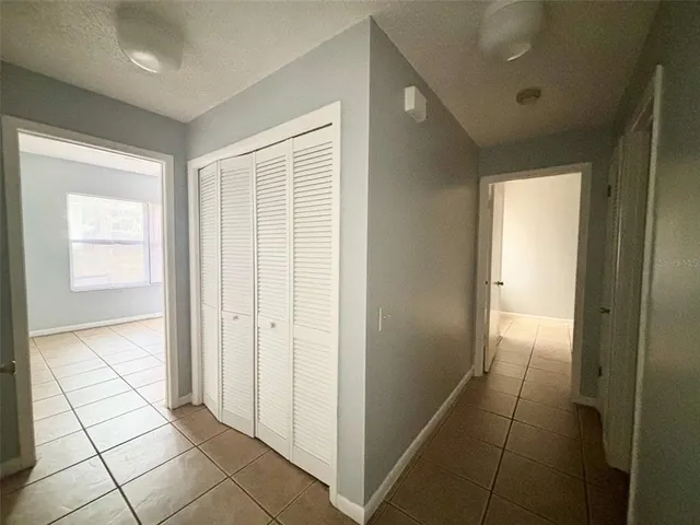 a view of a livingroom with a ceiling fan and entryway