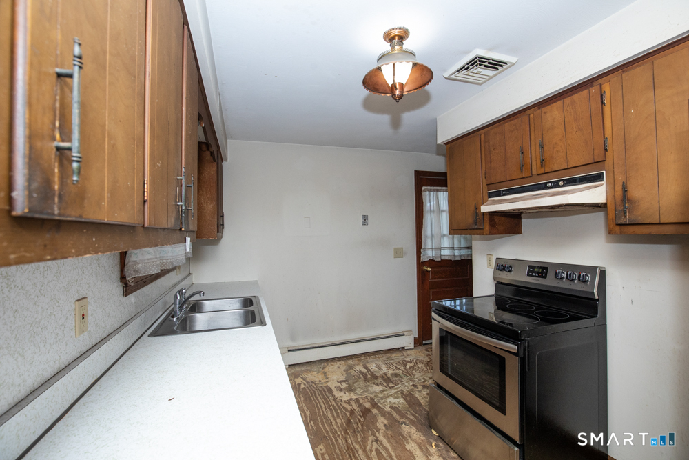 64 Somer Drive Meriden, CT 06451 - Photo 13 of 28 a kitchen with stainless steel appliances granite countertop a stove a sink and a refrigerator