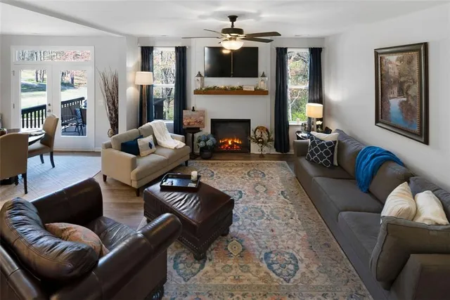 a living room with furniture fireplace and flat screen tv