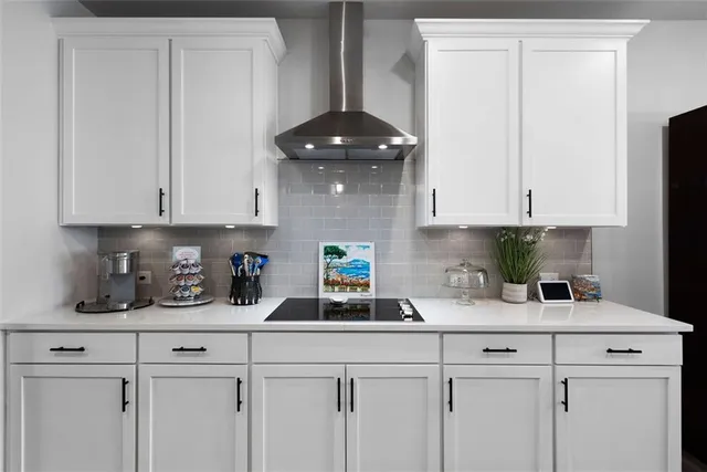 a kitchen with stainless steel appliances granite countertop a sink a stove and cabinets