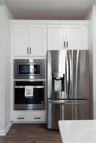 a kitchen with stainless steel appliances a refrigerator a stove and cabinets