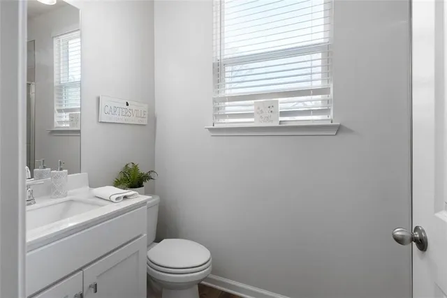 a bathroom with a toilet sink and mirror