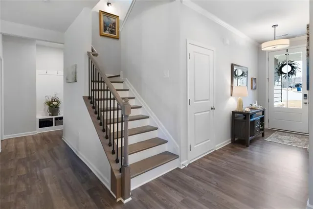 a view of a hallway with wooden floor and entryway