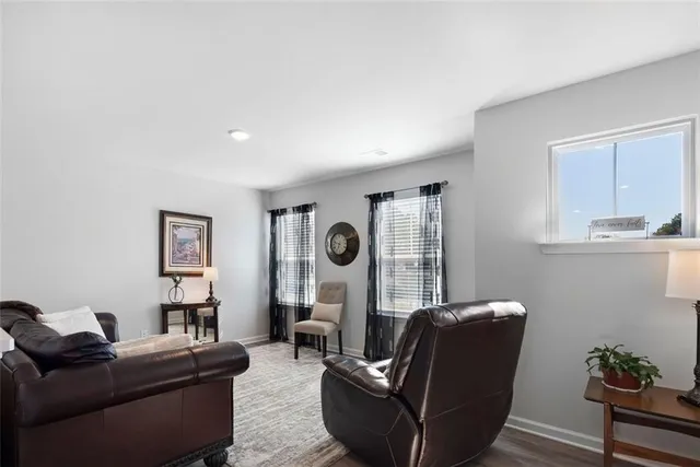 a living room with furniture and a wall painting