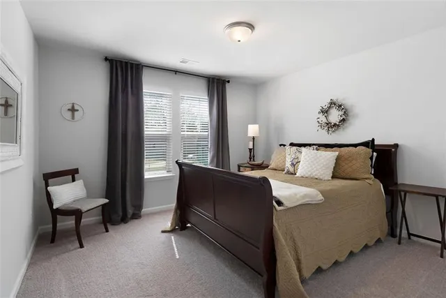 a bed room with a bed and a chair