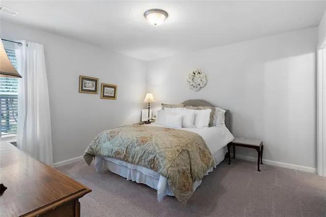 a spacious bedroom with a bed and a window