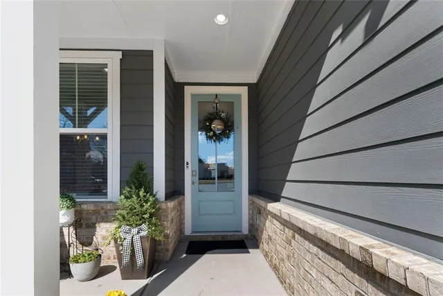 a view of a porch with potted plants