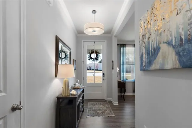 a view of a hallway with bathroom and wooden floor