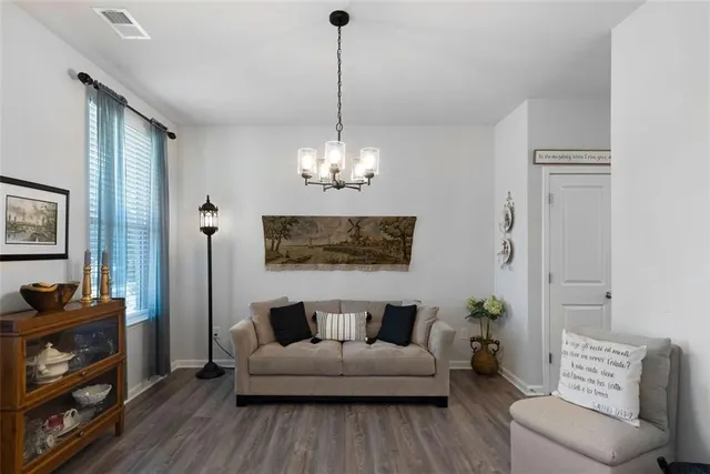a living room with furniture and a chandelier