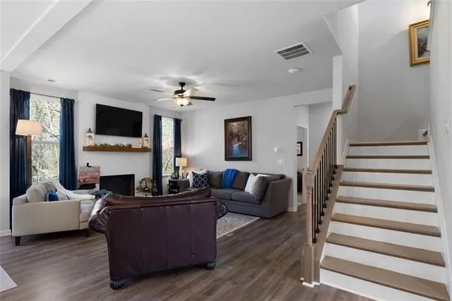 a living room with fireplace furniture and a flat screen tv