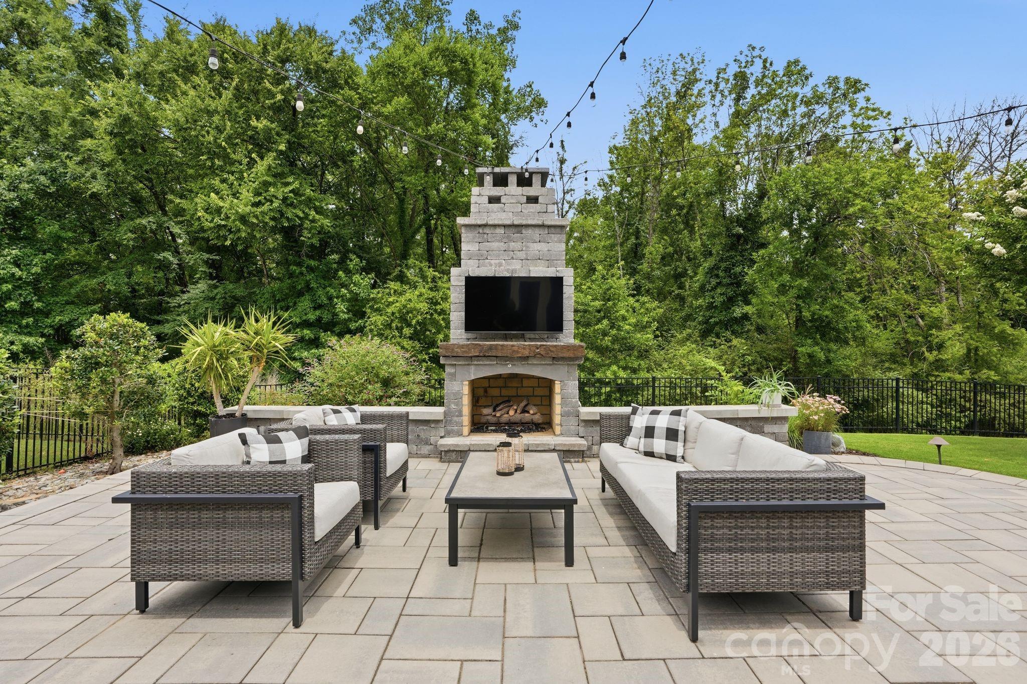 1086 Weir Court Fort Mill, SC 29708 - Photo 4 of 40 a view of a patio with couches table and chairs with potted plants and a yard