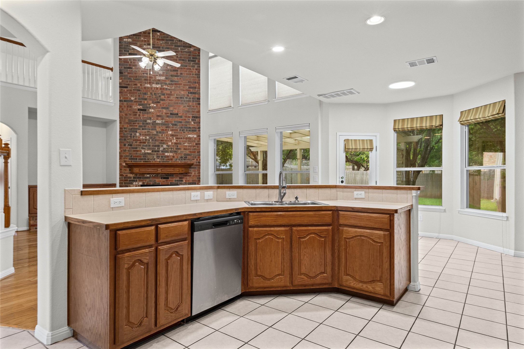 10700 Pointe View Drive Austin, TX 78738 - Photo 11 of 35 A well-appointed kitchen features a practical layout, tile flooring, and ample natural light from surrounding windows.