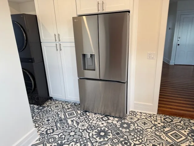 a refrigerator freezer sitting inside of a kitchen