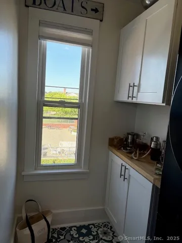 a bathroom with a granite countertop sink and a window