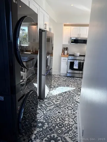 a kitchen with granite countertop a refrigerator and a stove