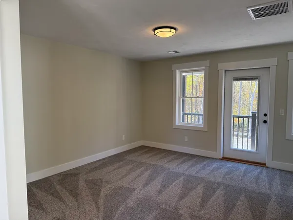 an empty room with windows and closet