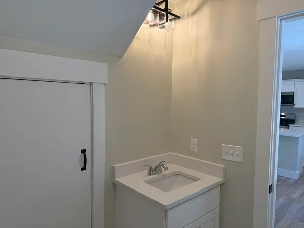 a view of a hallway with wooden floor