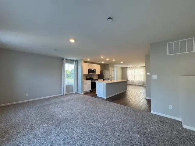 a view of a kitchen with a sink and cabinets