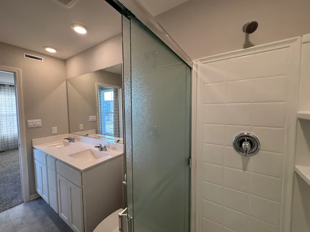 a bathroom with a sink a toilet and mirror