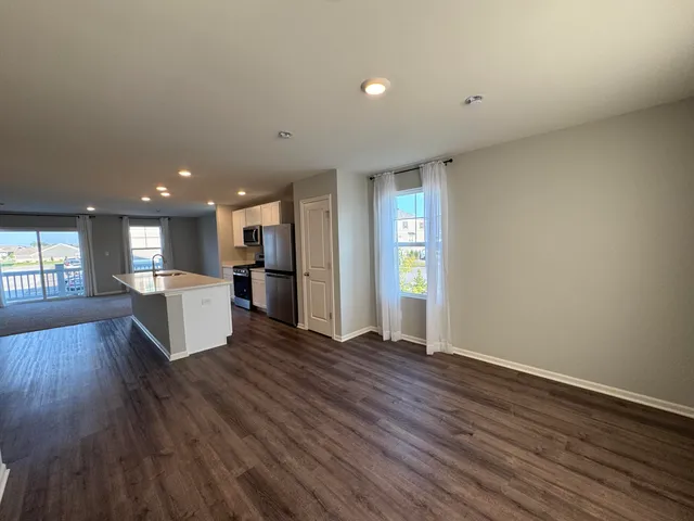 a view of kitchen with cabinets and wooden floor