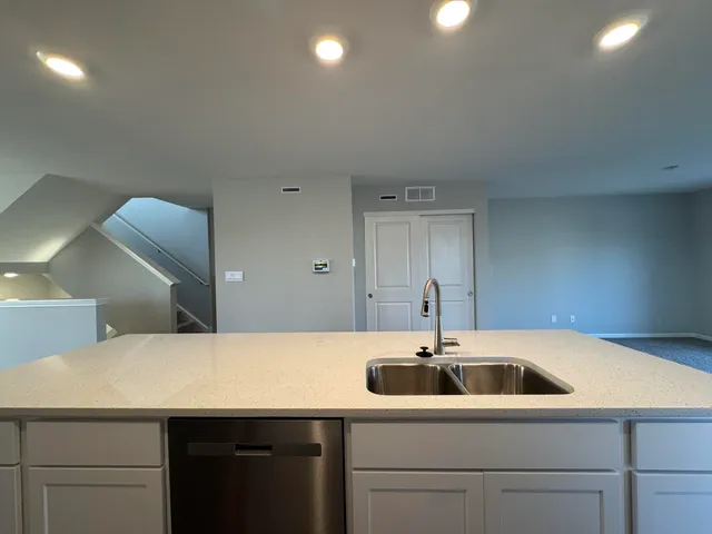 a kitchen with a sink and a refrigerator