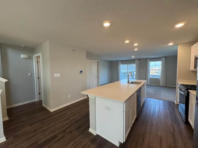 a kitchen with a stove a refrigerator and a microwave