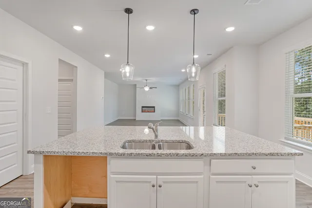 a bathroom with a granite countertop sink a large mirror and vanity