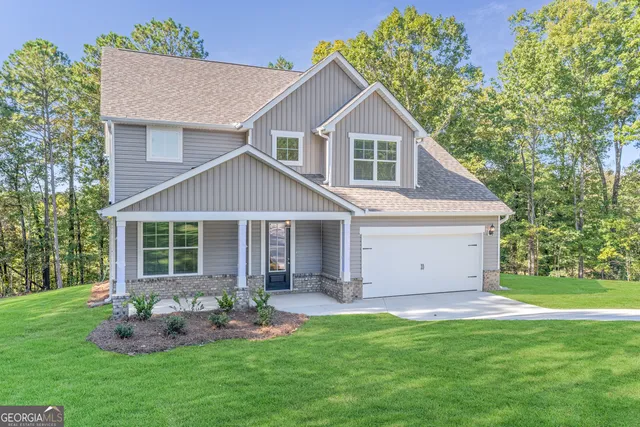 a front view of house with a garden and patio