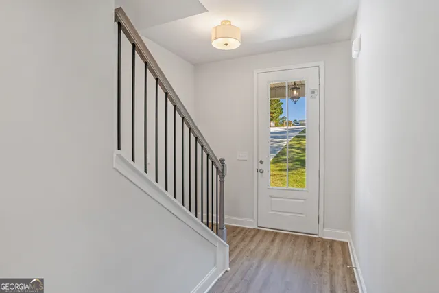 a view of an entryway with wooden floor