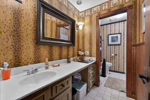 a bathroom with a toilet sink and mirror
