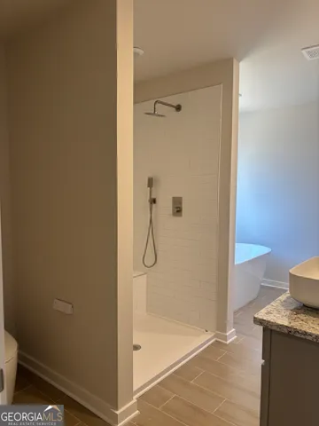a bathroom with a sink toilet and shower